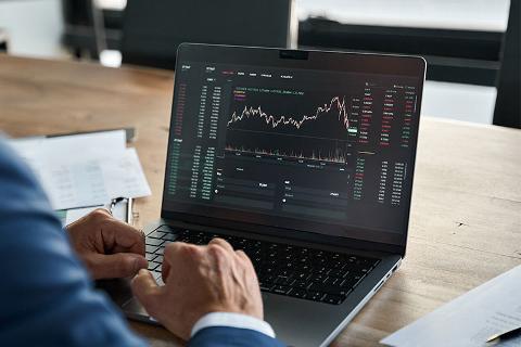 finance tracking on laptop in boardroom